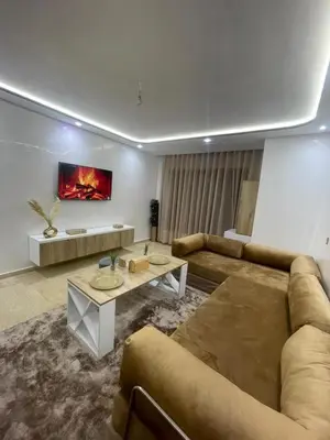 a living room with a couch and a table at Studio Chic & Neuf au Cœur de Bourgogne in Casablanca-Port
