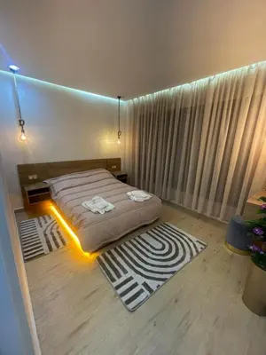 a bedroom with a bed with a light on it at Studio Chic & Neuf au Cœur de Bourgogne in Casablanca-Port