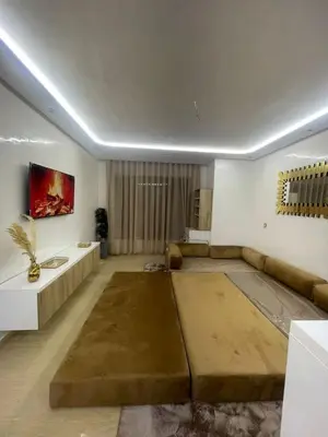 a living room with a couch and a table at Studio Chic & Neuf au Cœur de Bourgogne in Casablanca-Port