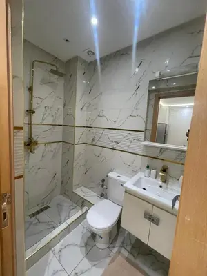 a white bathroom with a toilet and a sink at Studio Chic & Neuf au Cœur de Bourgogne in Casablanca-Port