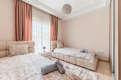 a bedroom with two beds and a window at Confort Urbain - Plein centre & Spacieux in Casablanca