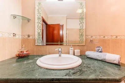 a bathroom counter with a sink and a mirror at Confort Urbain - Plein centre & Spacieux in Casablanca