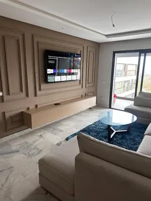 a living room with a couch and a tv at appartement de luxe a Mansouria in Mansouria