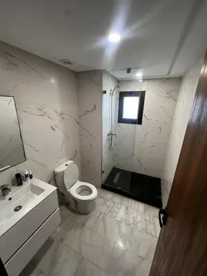 a bathroom with a toilet and a sink and a shower at appartement de luxe a Mansouria in Mansouria