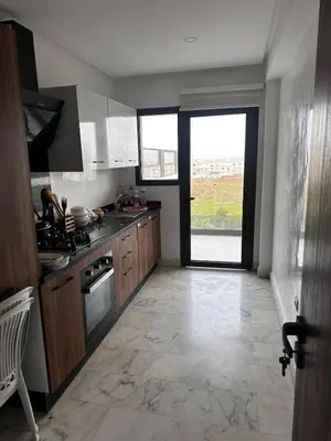 a kitchen with a large window and a large floor at appartement de luxe a Mansouria in Mansouria