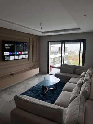 a living room with couches and a flat screen tv at appartement de luxe a Mansouria in Mansouria
