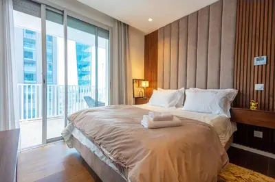 a bedroom with a large bed with a large window at Modern CFC Flat with Terrace Gym & City Views in Casablanca
