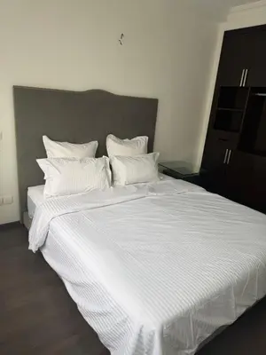 a large white bed with white sheets and pillows at Chez baya in Rabat