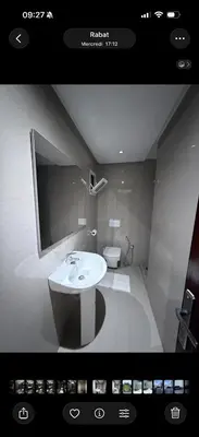 a bathroom with a white sink and a toilet at Chez baya in Rabat