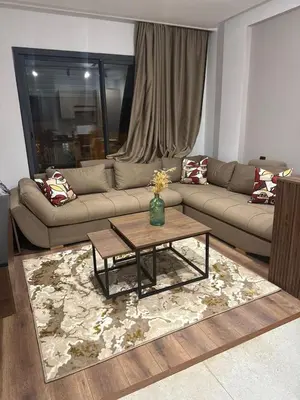 a living room with a couch and a coffee table at Studio Premium Maarif in Maarif