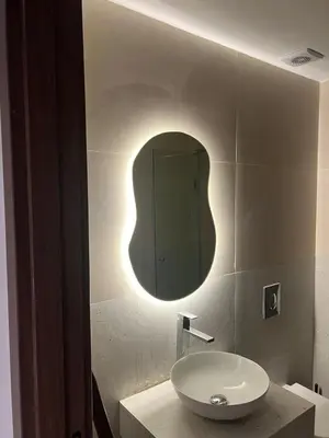 a bathroom with a sink and a mirror at Studio Premium Maarif in Maarif