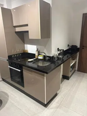 a kitchen with a sink and a stove at Studio Premium Maarif in Maarif