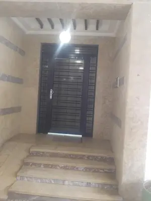 a door in a room with stairs and a light at اقامة جنان تمارة تمارة in Temara
