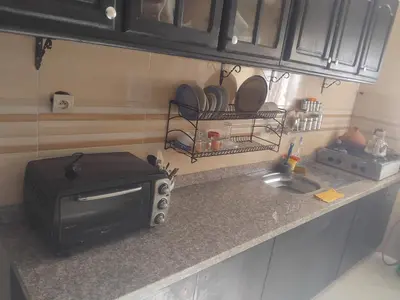 a kitchen counter with a microwave and a sink at اقامة جنان تمارة تمارة in Temara