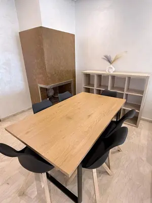 a wooden table and chairs in a room at Appartement Haut Standing in Casablanca