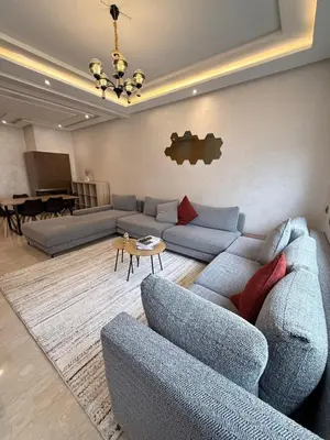 a living room with blue couches and a piano at Appartement Haut Standing in Casablanca
