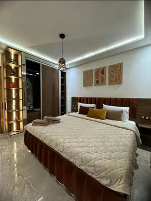 a bedroom with a large bed in a room at Luxury 1BR Apartment in Agdal Rabat in Rabat
