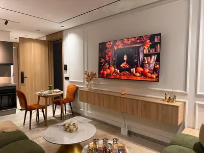 a living room with a television on a wall at Luxury Studio Casa Center in Casablanca