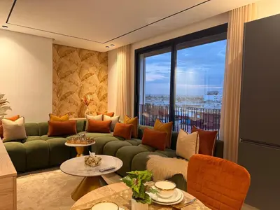 a living room with a green couch and a large window at Luxury Studio Casa Center in Casablanca