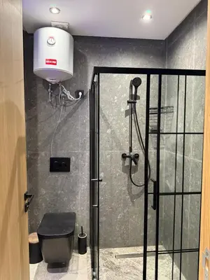 a bathroom with a shower with a toilet and a light at Luxury Studio Casa Center in Casablanca