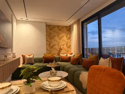 a living room with a green couch and a large window at Luxury Studio Casa Center in Casablanca