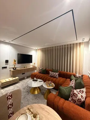 a living room with orange couches and a flat screen tv at Apparently city center in Casablanca