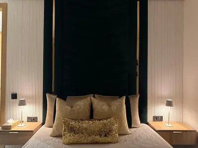 a bedroom with a large bed with a black headboard at Apparently city center in Casablanca