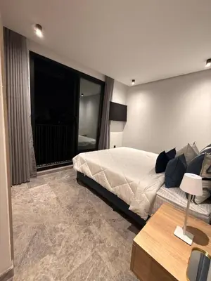 a bedroom with a bed and a large window at Jolie studio plein centre Casablanca in Casablanca