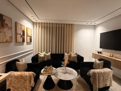 a living room with a couch and a tv at Jolie studio plein centre Casablanca in Casablanca