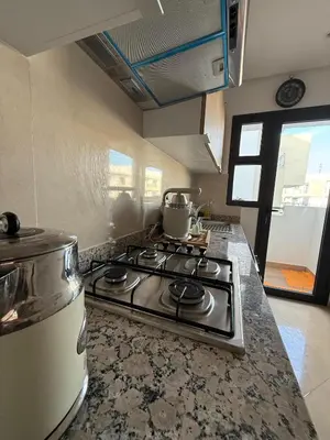 a kitchen with a stove with a pot on it at appartement de Lux le clos in Bouznika