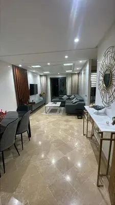 a living room with a couch and a table at Appartement magnifique et moderne in Temara