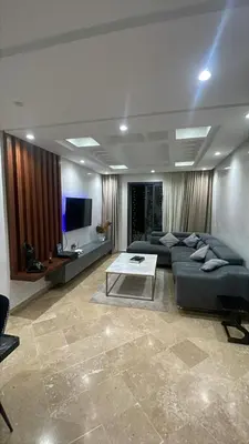 a large living room with a couch and a table at Appartement magnifique et moderne in Temara