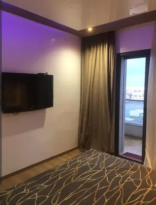 a bedroom with a flat screen tv on the wall at Appartement magnifique et moderne in Temara