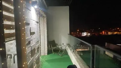 a view of a balcony of a building at night at Appartement magnifique et moderne in Temara