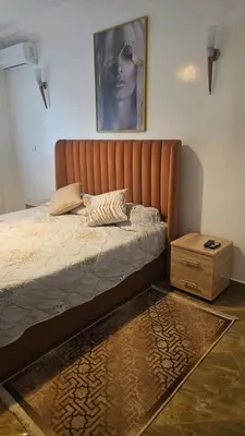 a bed in a bedroom with a picture on the wall at Stunning 2 bedrooms flat Palmier in Casablanca