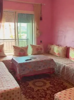 a living room with a couch and a table at Appartement al yakout 1 in Mansouria