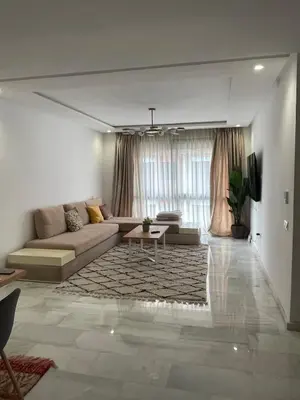 a living room with a couch and a table at Private Room,Piscine & Parking en cohabitation avec le hôte seulement à 6 min Airport MohamedV in Nouaceur