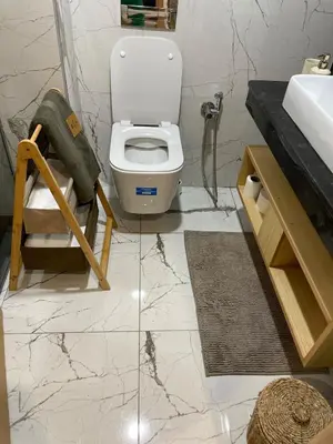 a bathroom with a white toilet and a sink at Private Room,Piscine & Parking en cohabitation avec le hôte seulement à 6 min Airport MohamedV in Nouaceur