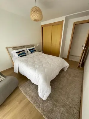 a bedroom with a large white bed in it at Private Room,Piscine & Parking en cohabitation avec le hôte seulement à 6 min Airport MohamedV in Nouaceur