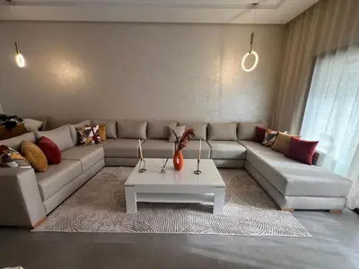 a living room with a couch and a table at El Mansouria Mohammedia, Magic House T5 in Mansouria