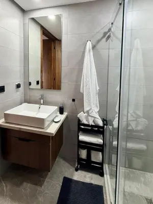 a bathroom with a sink and a shower at Luxury 1BR CFC with Pool, Balcony & City View in Casablanca
