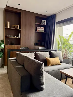 a living room with a couch and a table at Luxury 1BR CFC with Pool, Balcony & City View in Casablanca