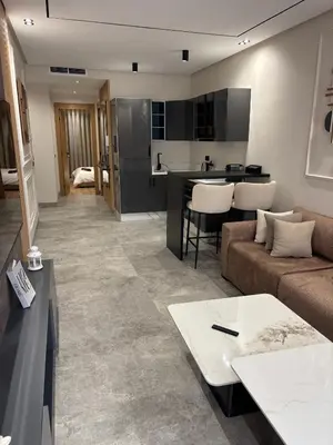 a living room with a couch and a kitchen at Bridge Collection - Mirage in Casablanca