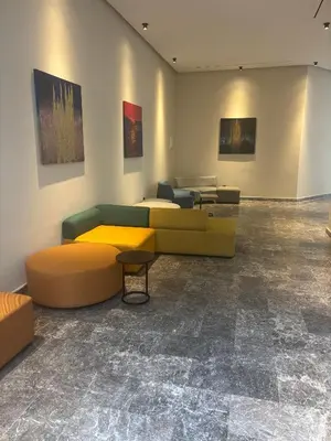 a room with couches and tables and paintings on the wall at Bridge Collection - Mirage in Casablanca
