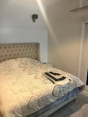 a bedroom with a bed with a zebra print blanket at Agdal Rabat superb furnished modern studio with large terrace in Rabat