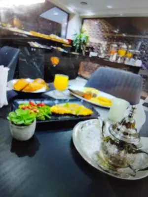a table with plates of food on top of it at Belle chambre pour 2 sidi maarouf HOTEL in Casablanca