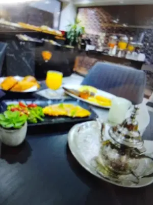 a table with plates of food on top of it at Belle chambre pour 2 sidi maarouf HOTEL in Casablanca