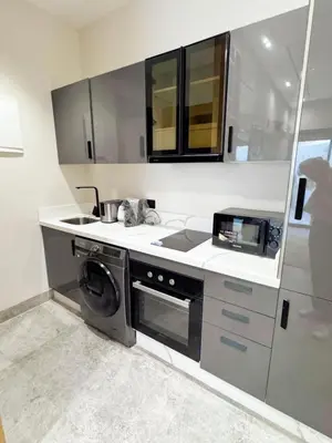 a kitchen with a washer and a sink and a microwave at anfa park residence beau living park in Casablanca