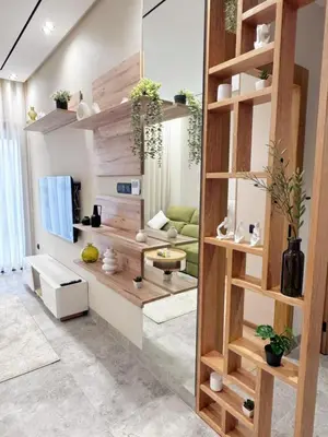 a living room with wooden shelves and a sink at anfa park residence beau living park in Casablanca
