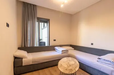 a living room with a large couch and a table at Piscine Chauffée Salle de Sport Balcon Panoramique in Mohammedia